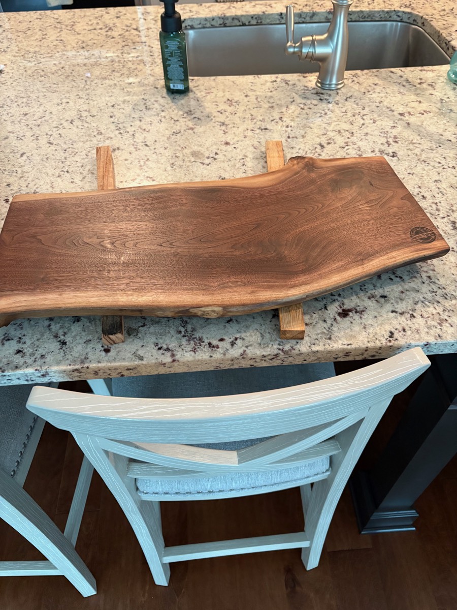 The Hearthstone — walnut serving board on display stand